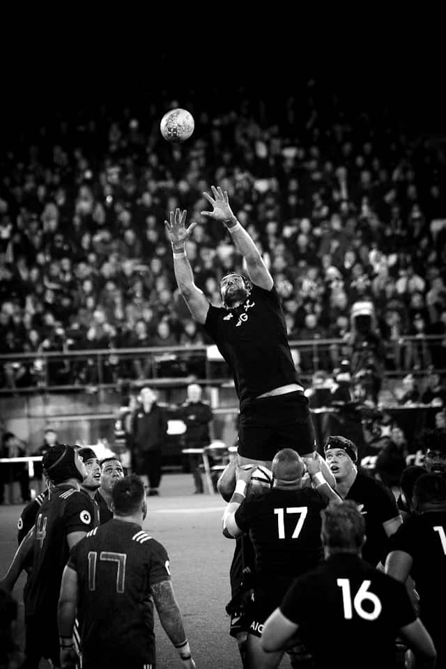 Team of rugby players support the reciever