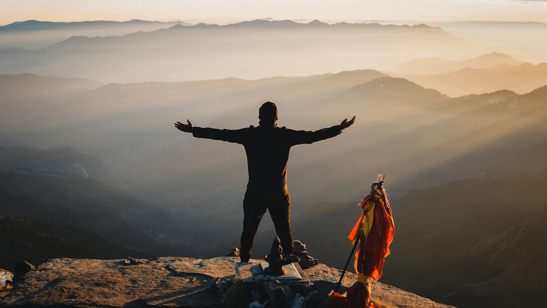 Man looking out above mountains