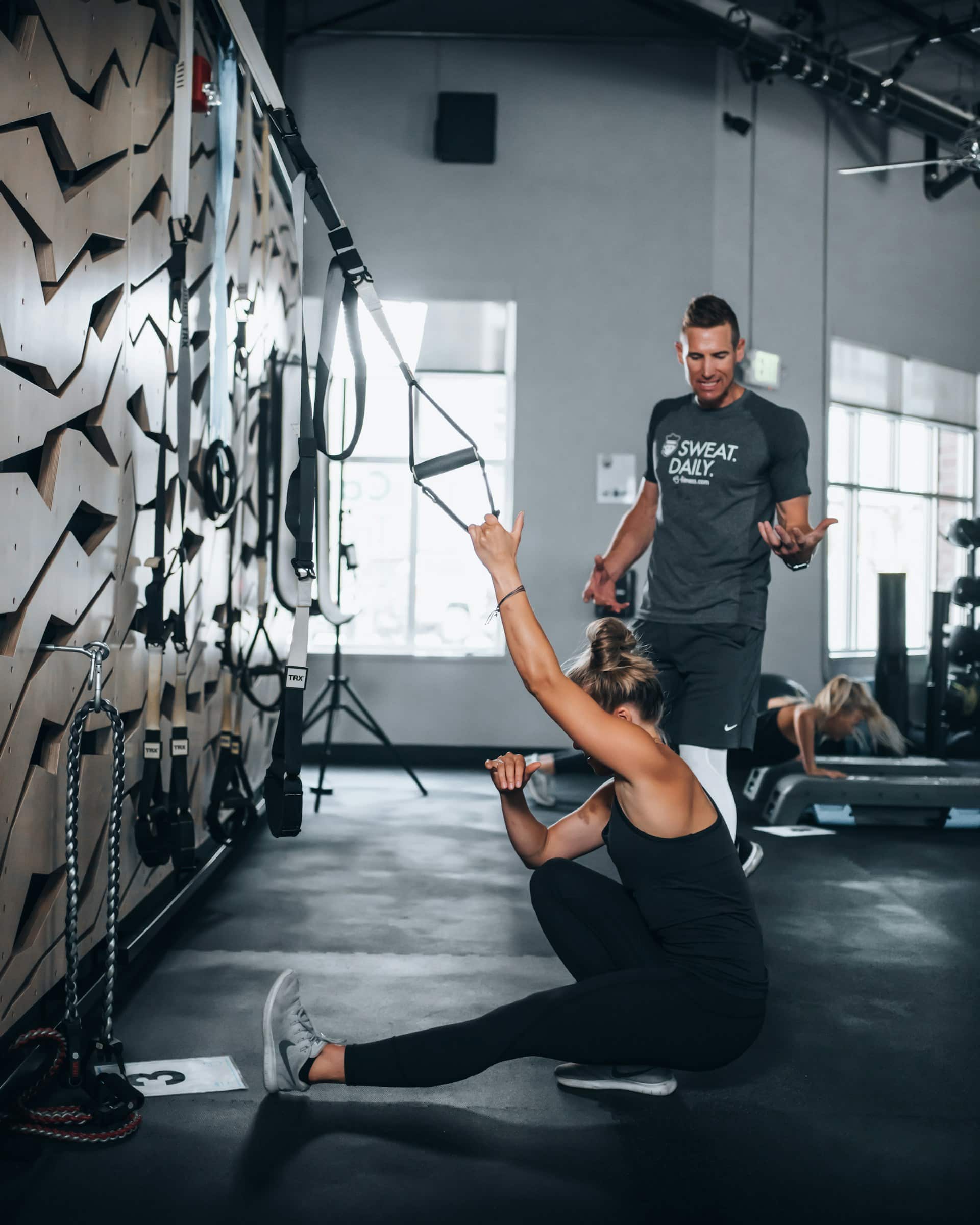 Woman and man training in the gym